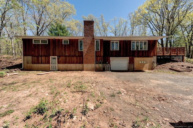 1037 Bartholomew Rd, Middletown, CT 06457 - back of house with a chimney, dirt driveway, a deck, and a garage