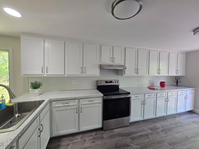 1037 Bartholomew Rd, Middletown, CT 06457 - kitchen with stainless steel electric range oven, a sink, under cabinet range hood, dark wood-type flooring, and white cabinets