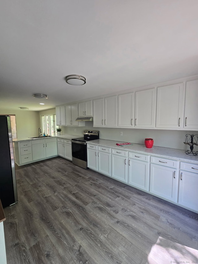 1037 Bartholomew Rd, Middletown, CT 06457 - kitchen featuring stainless steel appliances, light countertops, and dark wood-style flooring