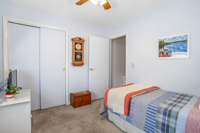 bedroom featuring a closet, ceiling fan, and light carpet