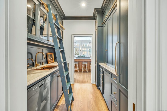 interior space featuring a sink, light wood-style flooring, dishwasher, and ornamental molding