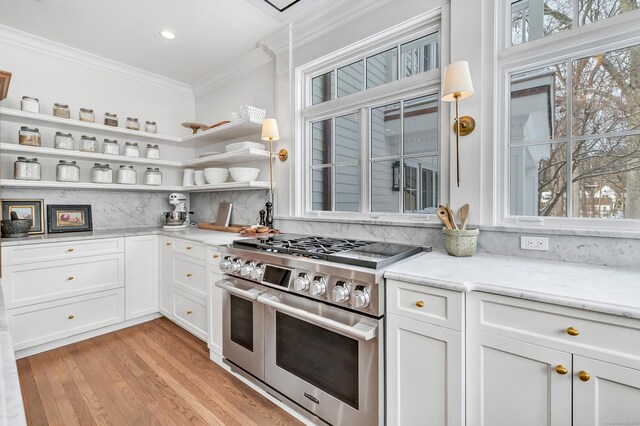 kitchen with white cabinets, open shelves, decorative backsplash, double oven range, and ornamental molding