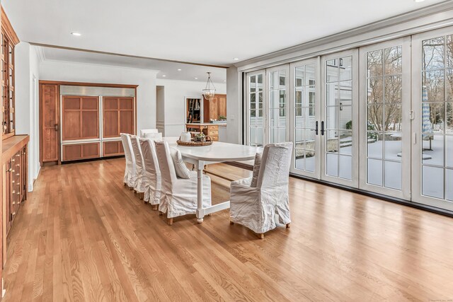 dining area featuring crown molding, recessed lighting, french doors, and light wood-type flooring