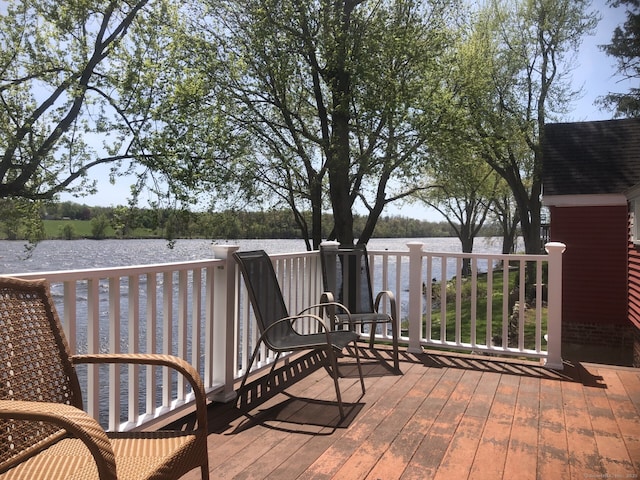wooden terrace featuring a water view
