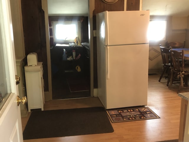 kitchen with freestanding refrigerator and wood finished floors