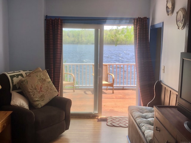 sitting room with wood finished floors and visible vents