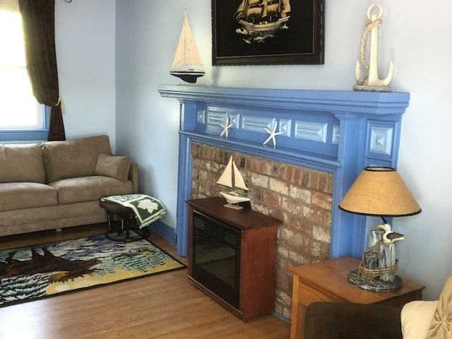 sitting room with wood finished floors and a fireplace