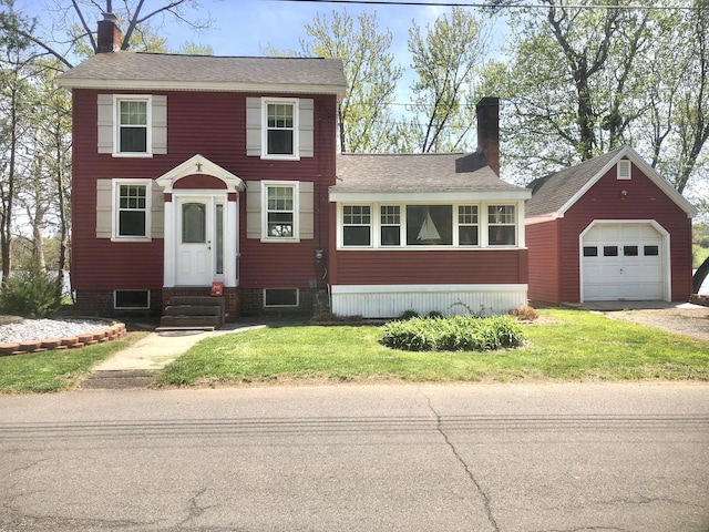 view of front of property with entry steps, an outdoor structure, a chimney, and a garage