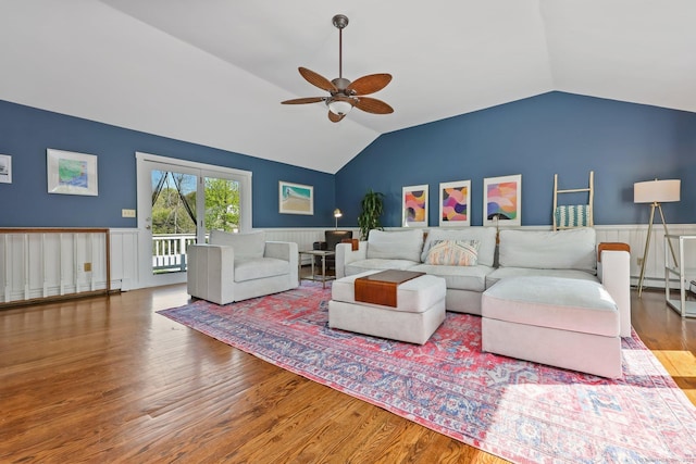 living area featuring wainscoting, ceiling fan, wood finished floors, and lofted ceiling
