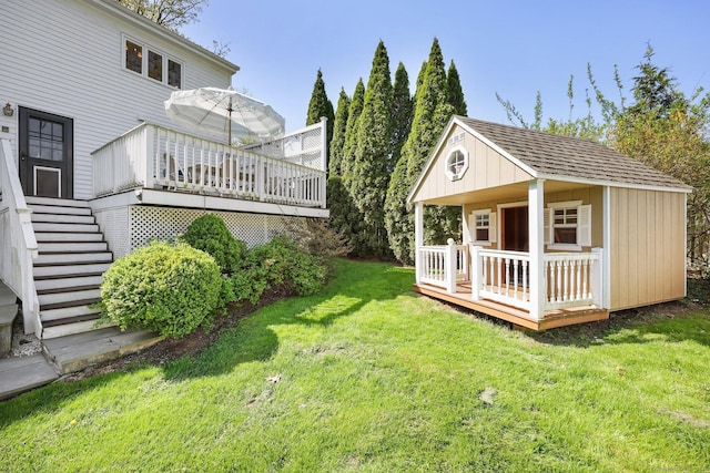 view of yard with a deck, an outbuilding, and stairs