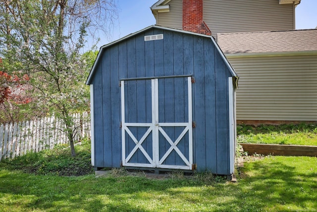 view of shed featuring fence