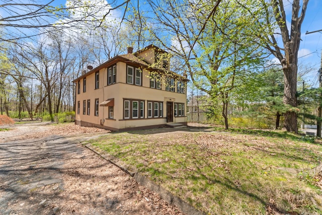 160 Laurel Hill Rd, Torrington, CT 06790 - back of house with stucco siding and a chimney