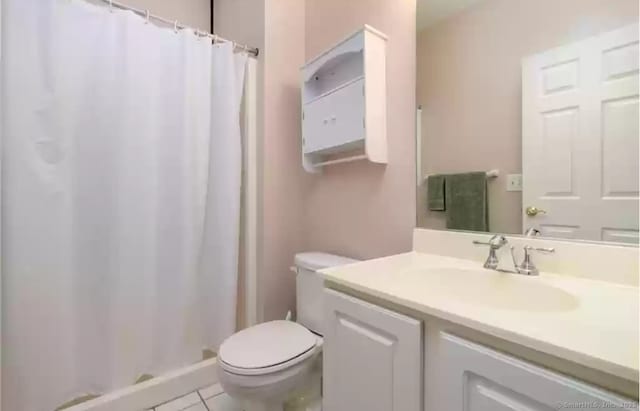 bathroom with toilet, a shower with curtain, tile patterned flooring, and vanity