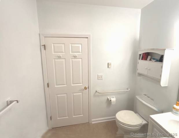 bathroom with baseboards and toilet