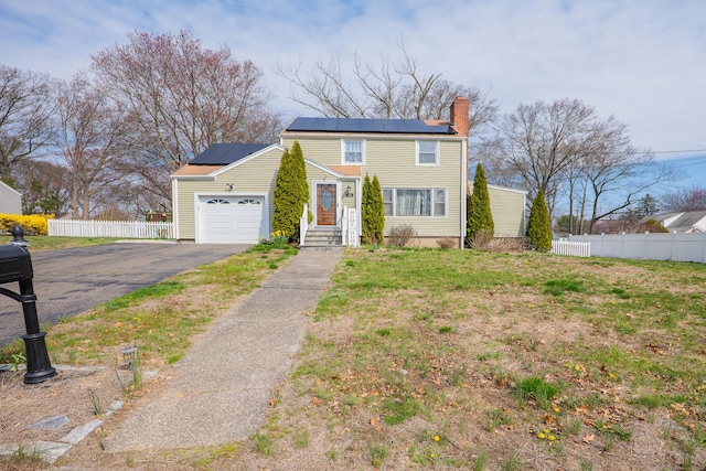 50 Fox Hill Rd, Stratford, CT 06614 - view of front of house featuring fence, a chimney, an attached garage, driveway, and solar panels