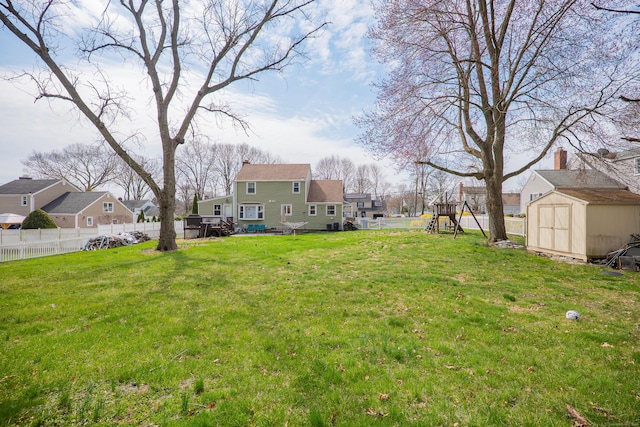 50 Fox Hill Rd, Stratford, CT 06614 - view of yard featuring a residential view, a storage unit, a fenced backyard, an outbuilding, and a playground