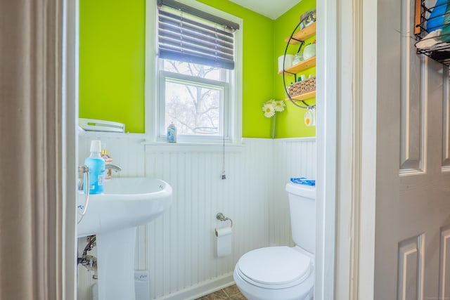 50 Fox Hill Rd, Stratford, CT 06614 - bathroom with toilet, a sink, and a wainscoted wall