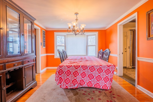50 Fox Hill Rd, Stratford, CT 06614 - dining area featuring light wood-type flooring, baseboards, crown molding, and a chandelier