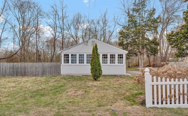 exterior space with fence and a lawn
