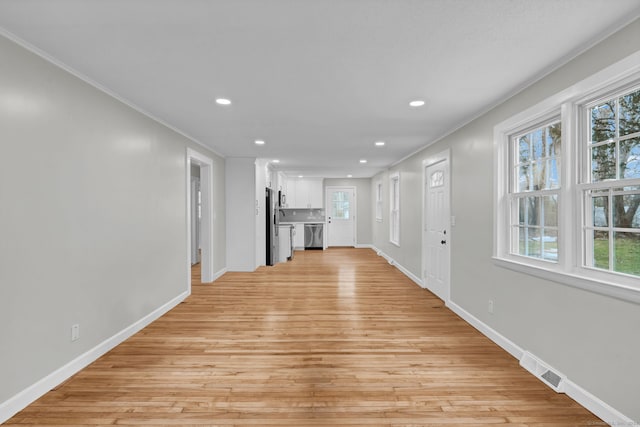 unfurnished living room with crown molding, recessed lighting, and light wood-type flooring