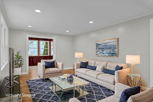 living room with light wood-type flooring, recessed lighting, and baseboards
