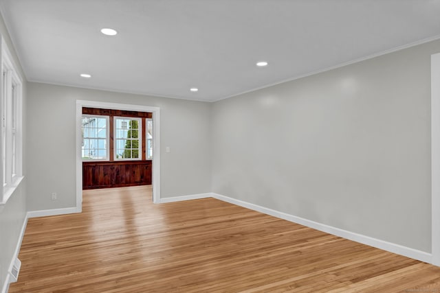 spare room featuring recessed lighting, baseboards, ornamental molding, and light wood-style floors