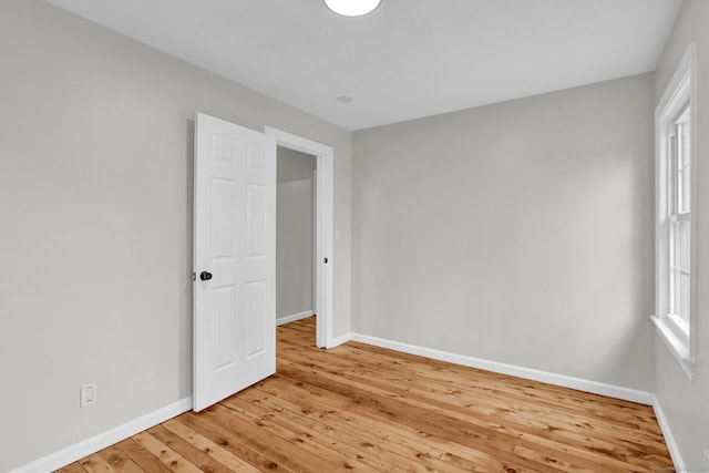 unfurnished bedroom with light wood-style floors and baseboards