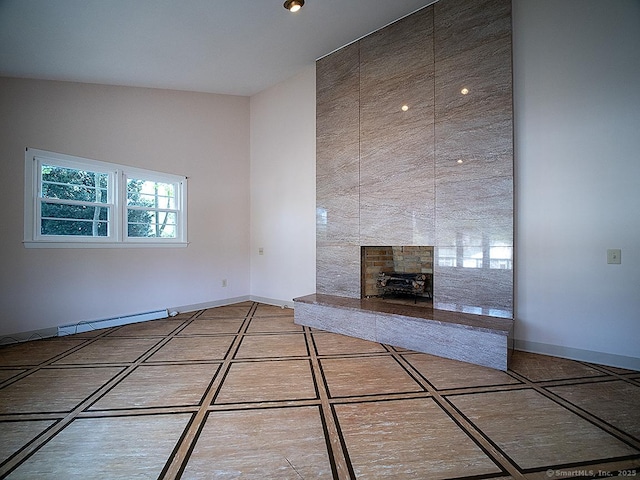 unfurnished living room with baseboards and a tile fireplace
