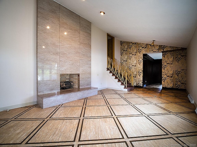 unfurnished living room with baseboards and stairs