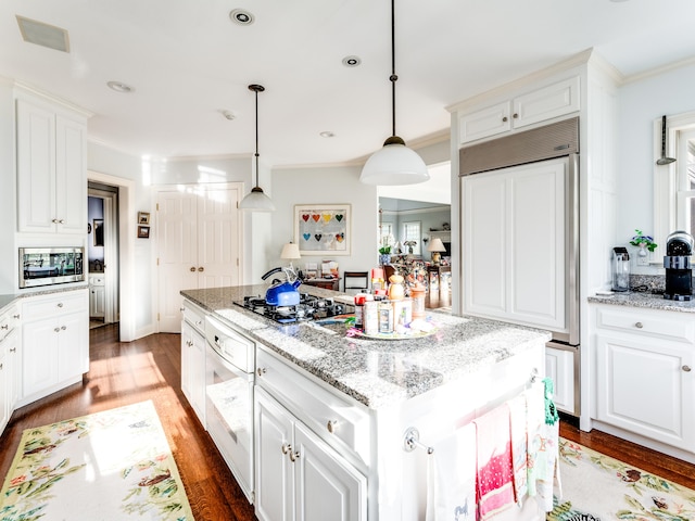 5 Clarks Ln, Old Lyme, CT 06371 - kitchen featuring paneled fridge, stainless steel microwave, crown molding, a center island, and white cabinets