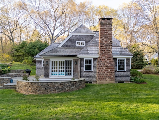 5 Clarks Ln, Old Lyme, CT 06371 - back of house with a lawn, a chimney, roof with shingles, and a patio area