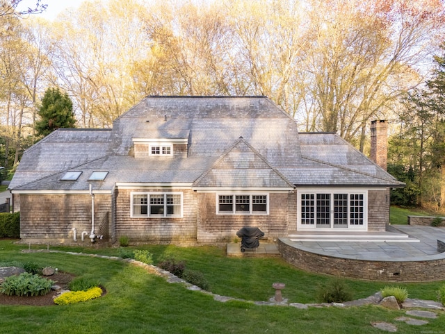 5 Clarks Ln, Old Lyme, CT 06371 - back of property with a patio area, a yard, a chimney, and a shingled roof