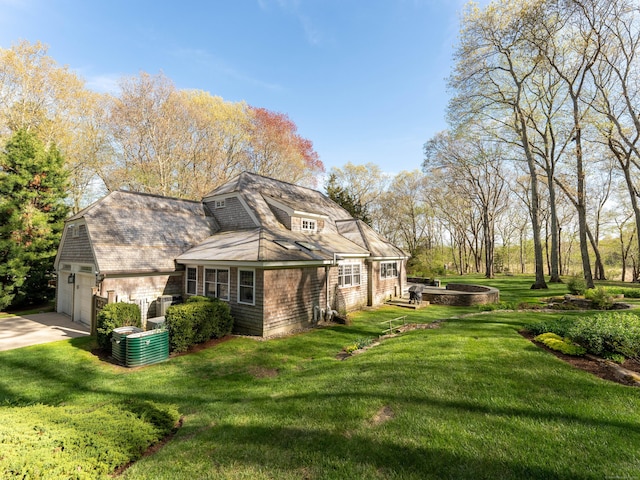 5 Clarks Ln, Old Lyme, CT 06371 - view of home's exterior with concrete driveway, a lawn, an attached garage, and central AC
