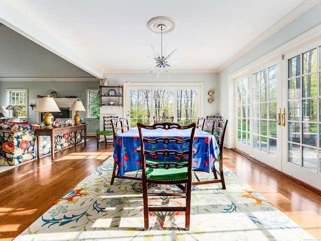 5 Clarks Ln, Old Lyme, CT 06371 - dining area featuring wood finished floors, a chandelier, crown molding, baseboards, and french doors