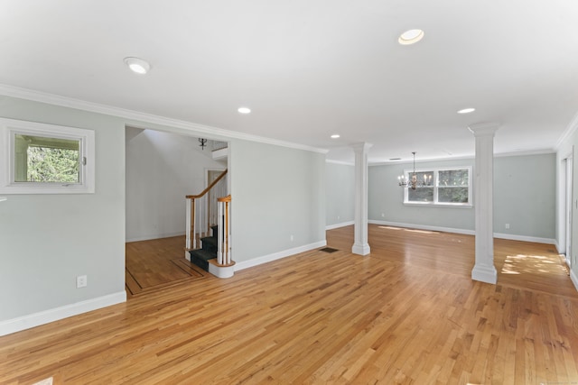 below grade area featuring crown molding, light wood-style flooring, stairs, and a wealth of natural light