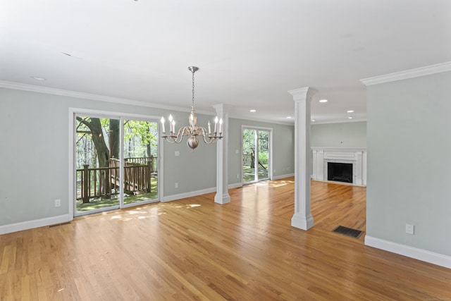 unfurnished dining area featuring ornate columns, baseboards, visible vents, and light wood-type flooring