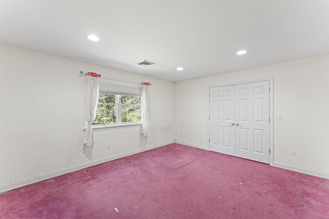 spare room with recessed lighting, baseboards, carpet floors, and visible vents