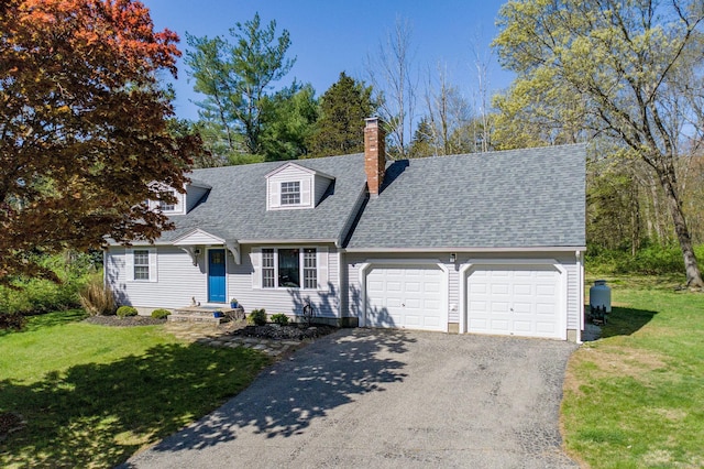 cape cod house with a front lawn, a chimney, a shingled roof, an attached garage, and driveway