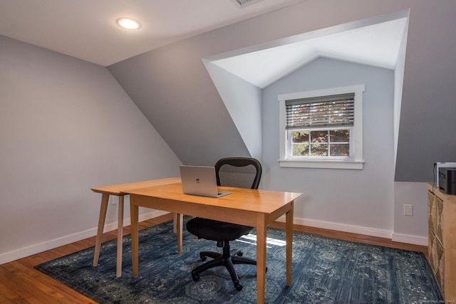 office space with baseboards, vaulted ceiling, and wood finished floors