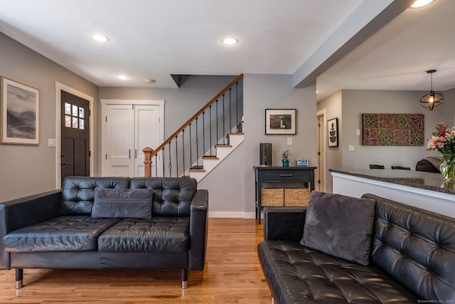 living room with stairs, recessed lighting, baseboards, and light wood-type flooring