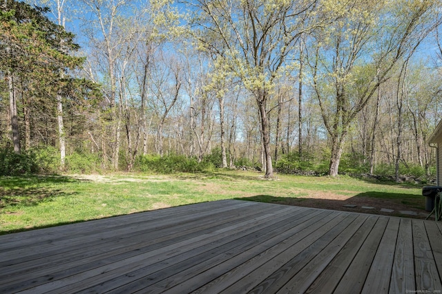 wooden deck with a lawn