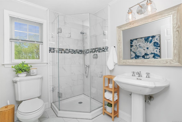 bathroom featuring a shower stall, baseboards, toilet, and ornamental molding
