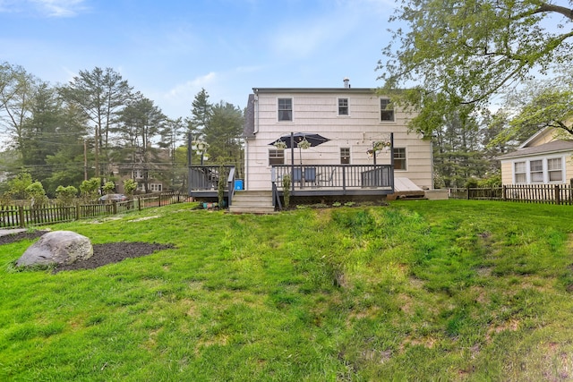 back of house with a deck