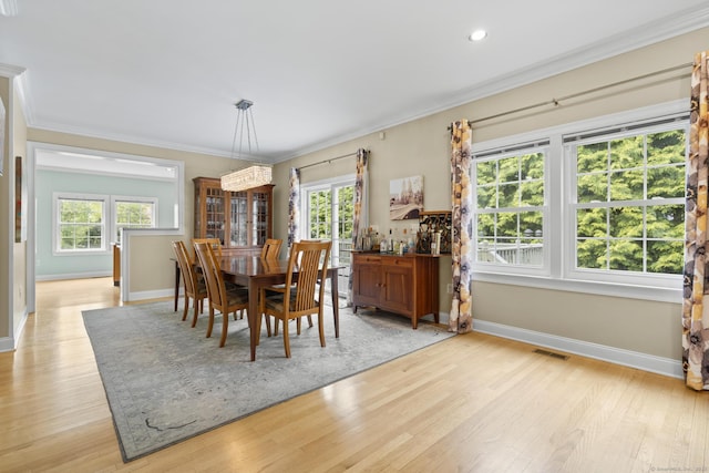 dining room with baseboards, a wealth of natural light, light wood-style floors, and visible vents