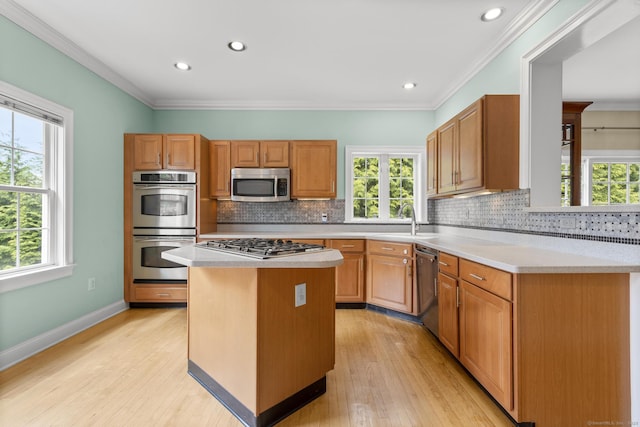kitchen featuring tasteful backsplash, light countertops, and appliances with stainless steel finishes