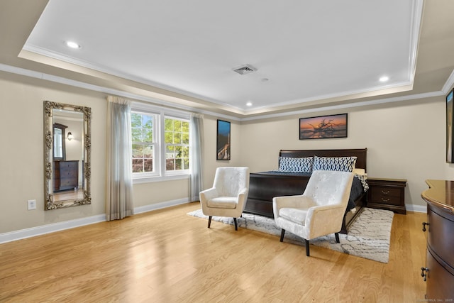 bedroom with crown molding, visible vents, a raised ceiling, light wood-style floors, and recessed lighting