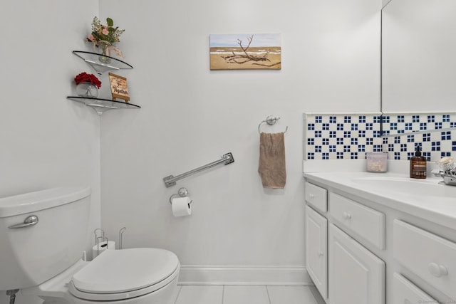 bathroom featuring toilet, baseboards, tile patterned floors, and vanity