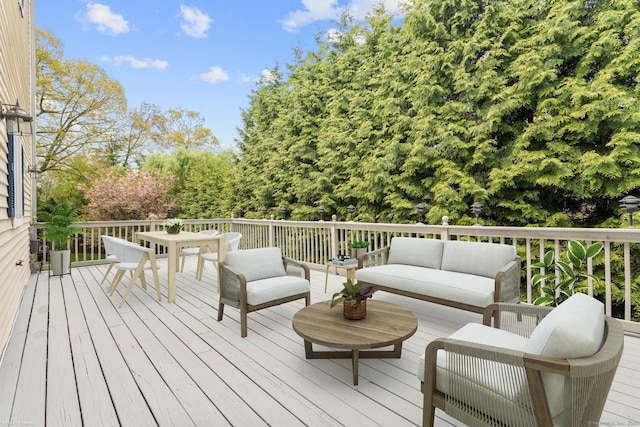 wooden deck featuring outdoor dining space and an outdoor living space