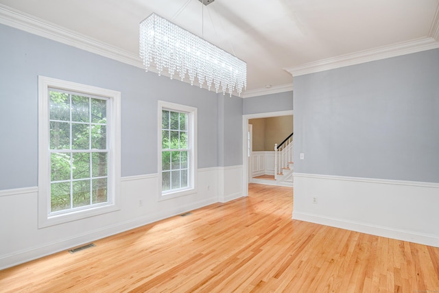 127 Hanover Rd, Newtown, CT 06470 - unfurnished room featuring a chandelier, stairway, plenty of natural light, wood finished floors, and ornamental molding