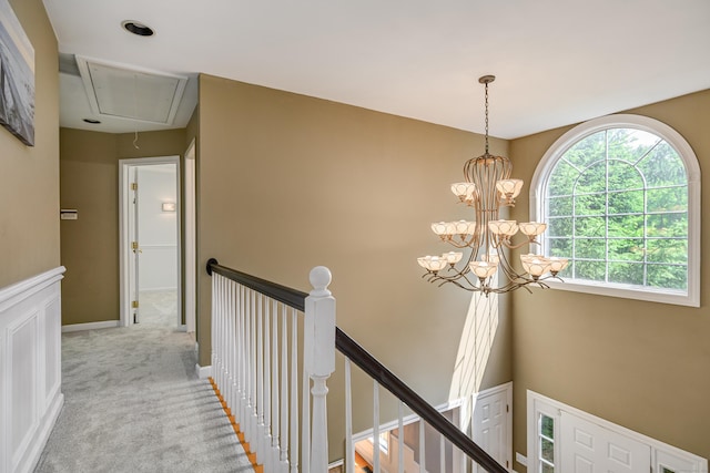 127 Hanover Rd, Newtown, CT 06470 - hallway with attic access, an upstairs landing, carpet flooring, and a chandelier